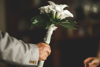 Cropped hand of man holding flower bouquet