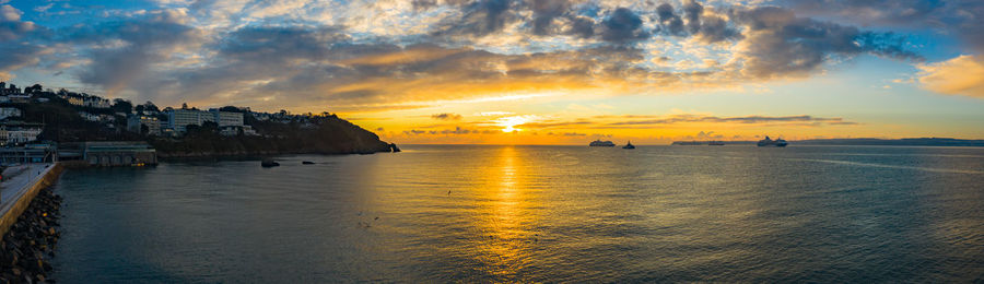 Scenic view of sea against sky at sunset