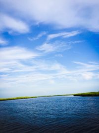 Scenic view of calm sea against cloudy sky