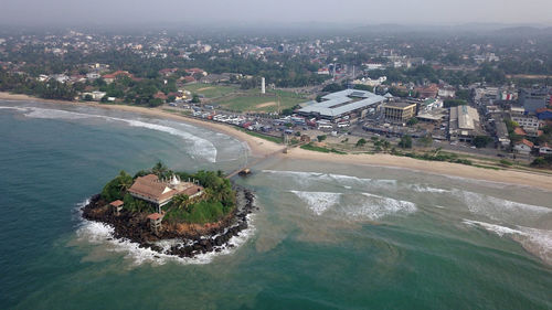 High angle view of sea and buildings in city