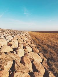Scenic view of rocks on field against sky