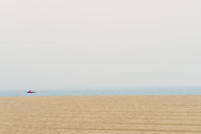 Scenic view of beach against clear sky