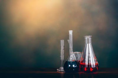 Liquids in laboratory glassware on table