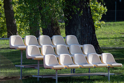 Empty chairs against trees