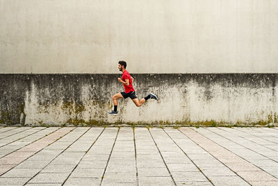 Young man running fast in the park