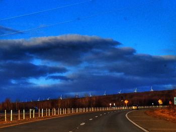 Road against blue sky at night