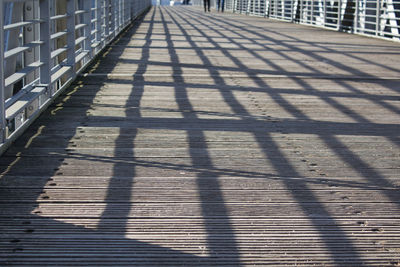 Shadow of railing on footpath