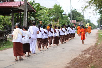 Rear view of people walking in temple