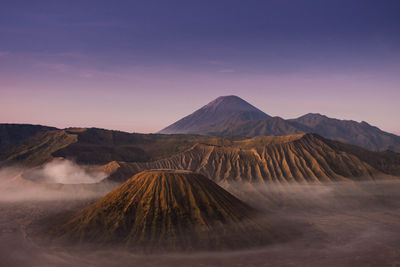 Scenic view of volcanic landscape against sky during sunset