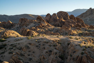 Scenic view of landscape and mountains against clear sky