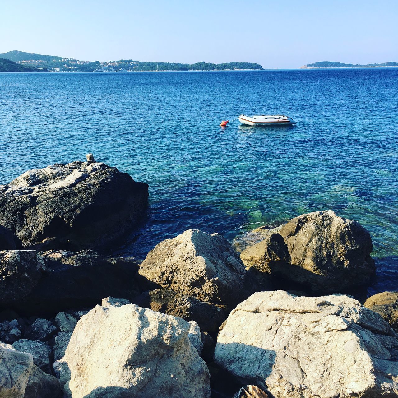 SCENIC VIEW OF SEA AND ROCKS AGAINST SKY