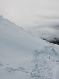 Scenic view of snow covered mountain against sky