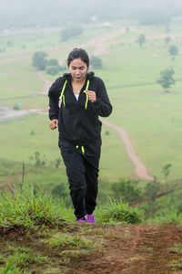 Portrait of a young woman standing on grass