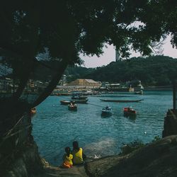 Boats sailing in sea against sky