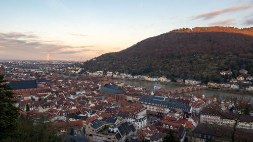 High angle shot of townscape against sky at sunset