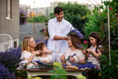 People in traditional clothing on table against wall