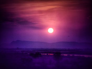 Illuminated lights against sky at night