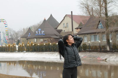 Young woman standing in rain during winter