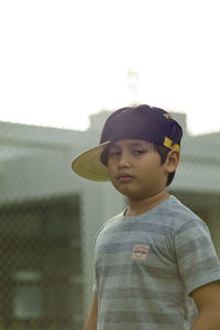 Portrait of boy standing against clear sky