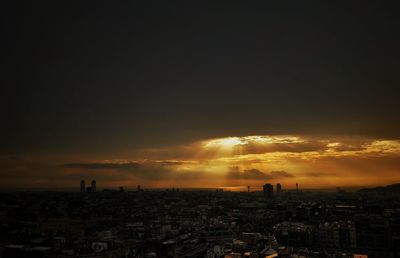 Aerial view of cityscape against sky during sunset