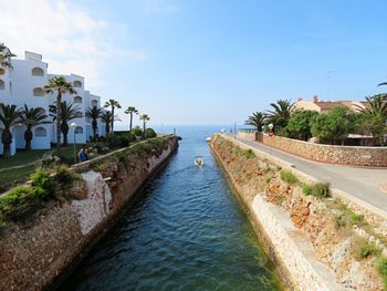 View of swimming pool by sea against sky