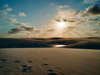 Scenic view of beach against sky during sunset