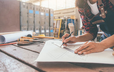 Midsection of woman working on table