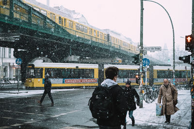 Full length of man on snow covered city in winter