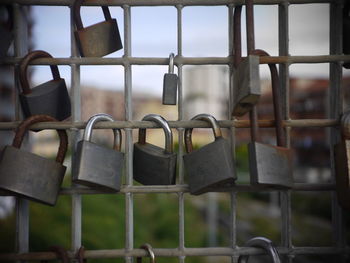 Close-up of padlocks hanging on railing