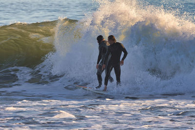 Man surfing on sea shore