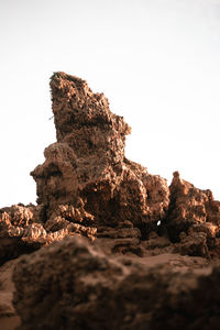 Low angle view of rock formation on land against sky