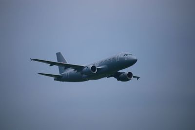 Low angle view of airplane flying in sky