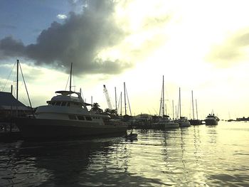 Boats in harbor at sunset