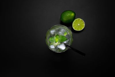 Close-up of green fruits against black background