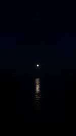 Scenic view of sea against sky at night