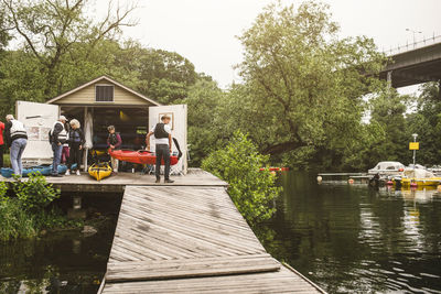 Senior men and women on jetty over sea during kayaking course