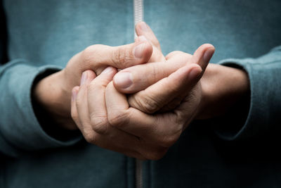 Close-up of man holding hands