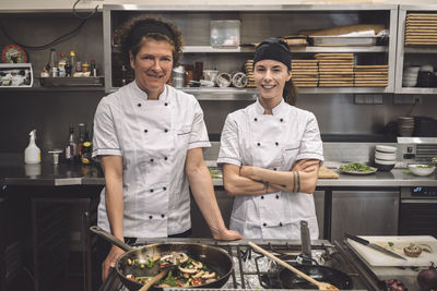 Portrait of smiling female chefs in commercial kitchen