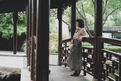 Woman standing by railing