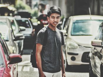 Portrait of smiling man standing in car