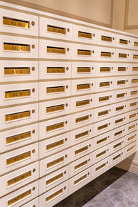 Vertical photo of letter mailboxes in postal room of condominium building