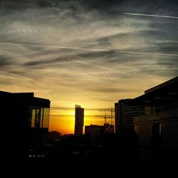 Low angle view of buildings against sky at sunset