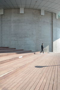 Side view of man walking in corridor