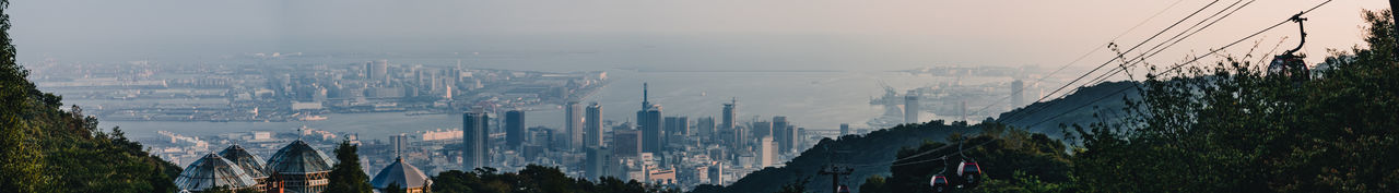 Panoramic view of modern buildings in city against sky