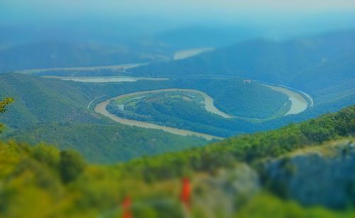 Scenic view of green landscape against sky