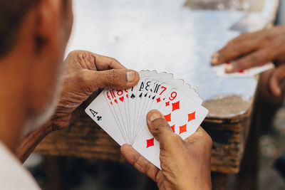 Midsection of man playing with text on table