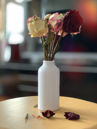 White vase with dried roses