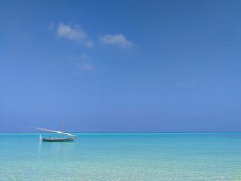 Scenic view of sea against blue sky