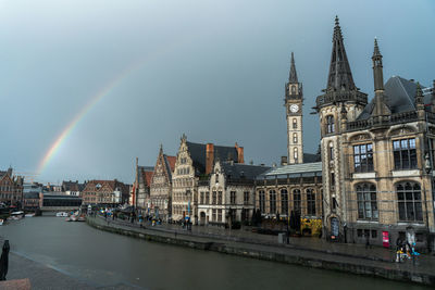 View of rainbow over city buildings