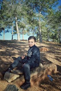 Portrait of young man sitting on land